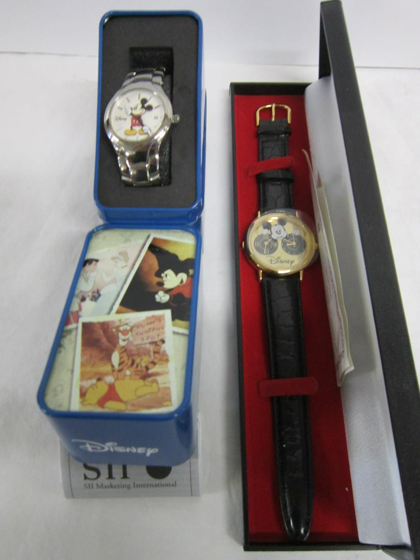 2 Mickey Mouse Wrist Watches: Two Mickey Mouse Wrist Watches, both like new in original boxes including: SII stainless steel,with date featuring Mickey with arm "hands", adjustable watch band in hard tin box with instruction bookl