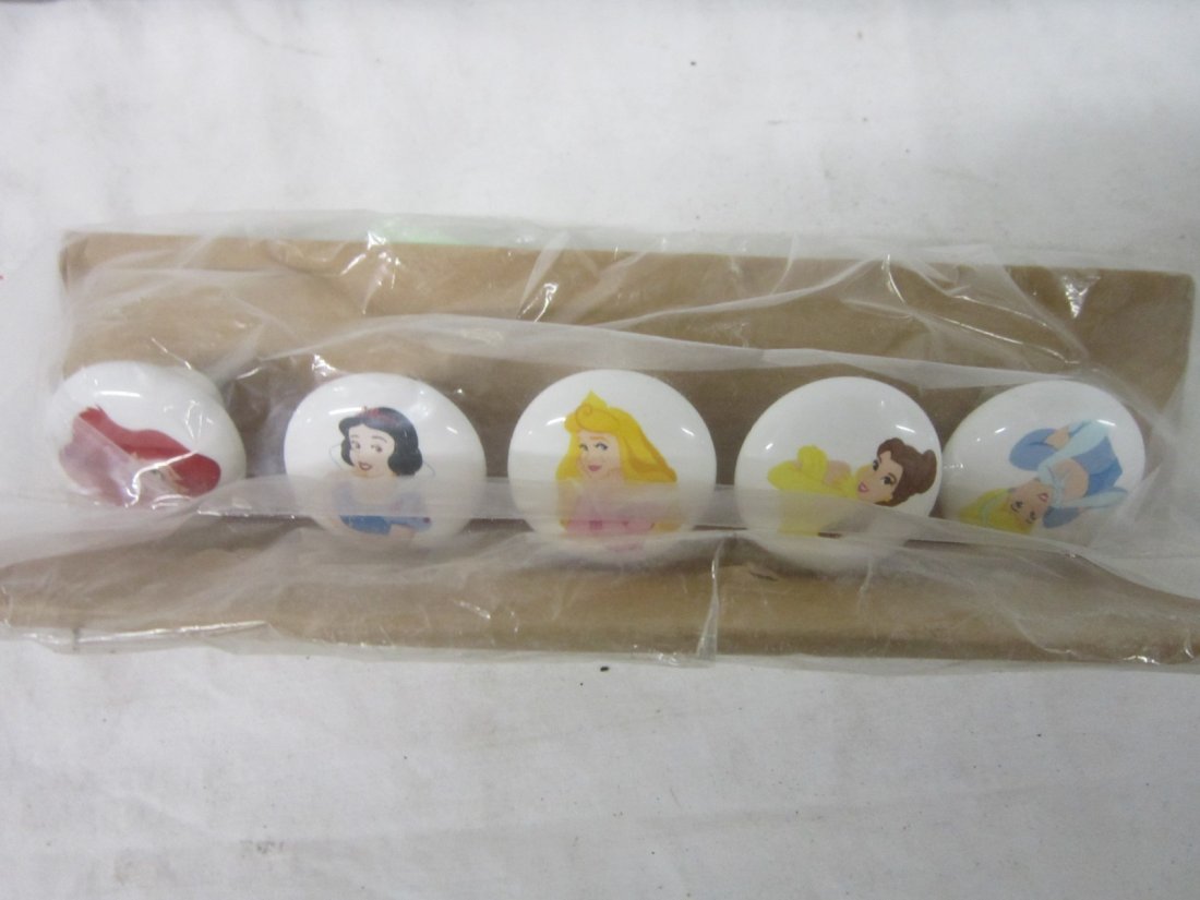 Set Porcelain Disney drawer pulls: Set Porcelain Disney drawer pulls, set of five including; Arial, Snow White, Aurora, Belle and Cinderella, all with hold bolts, 1 1/2" dia. x 1". Condition; no issues noted