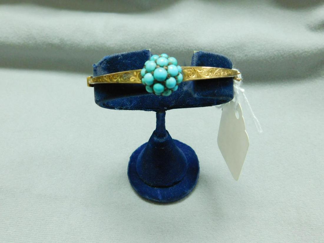 Antique English Gold & Turquoise Bracelet: Antique English Gold & Turquoise Bracelet, 9 K (375) y gold hinged bangle bracelet with scroll chaised frame and central dome holding 19 graduated round cabochon turquoise in a silver mount "S & P" ma