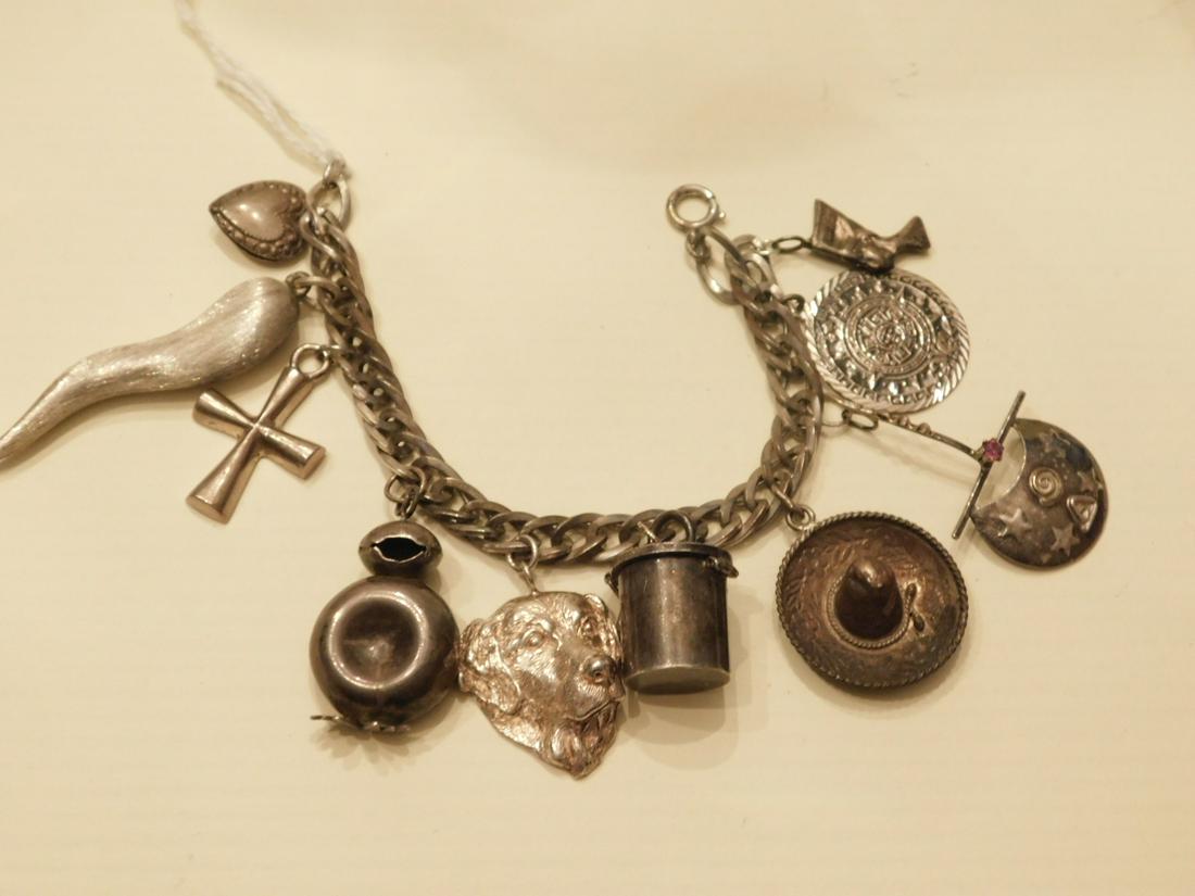 Sterling Silver Charm Bracelet: Sterling Silver Charm Bracelet, 6 3/4" oval link bracelet with 10 charms, early to mid 20th C, 2.33 ozts. [6] CONDITION: Good, used condition, tarnished.