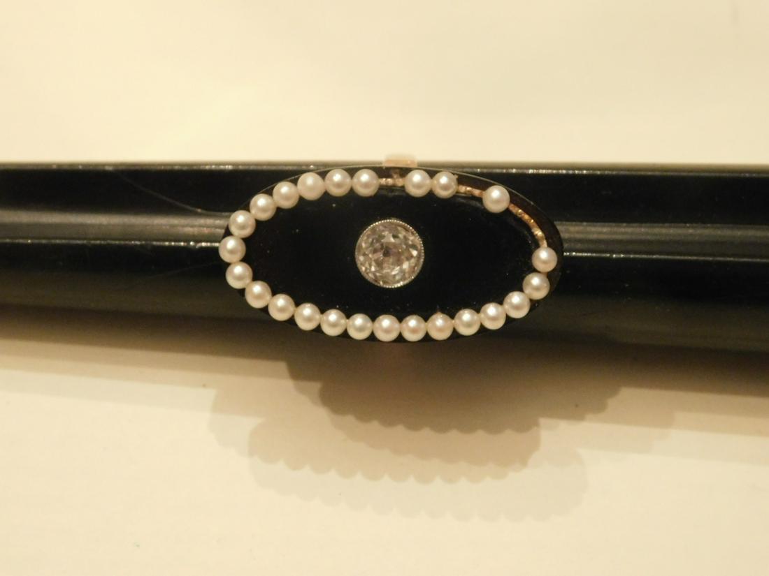Rose Gold Diamond, Onyx & Pearl Ring: Rose Gold Diamond, Onyx and Pearl Ring, the gold band is set with a 32 x 17 mm black onyx platform circled by 2mm pearls and a central white gold bezel set approx. 1 ct mine cut round diamond; size 7 