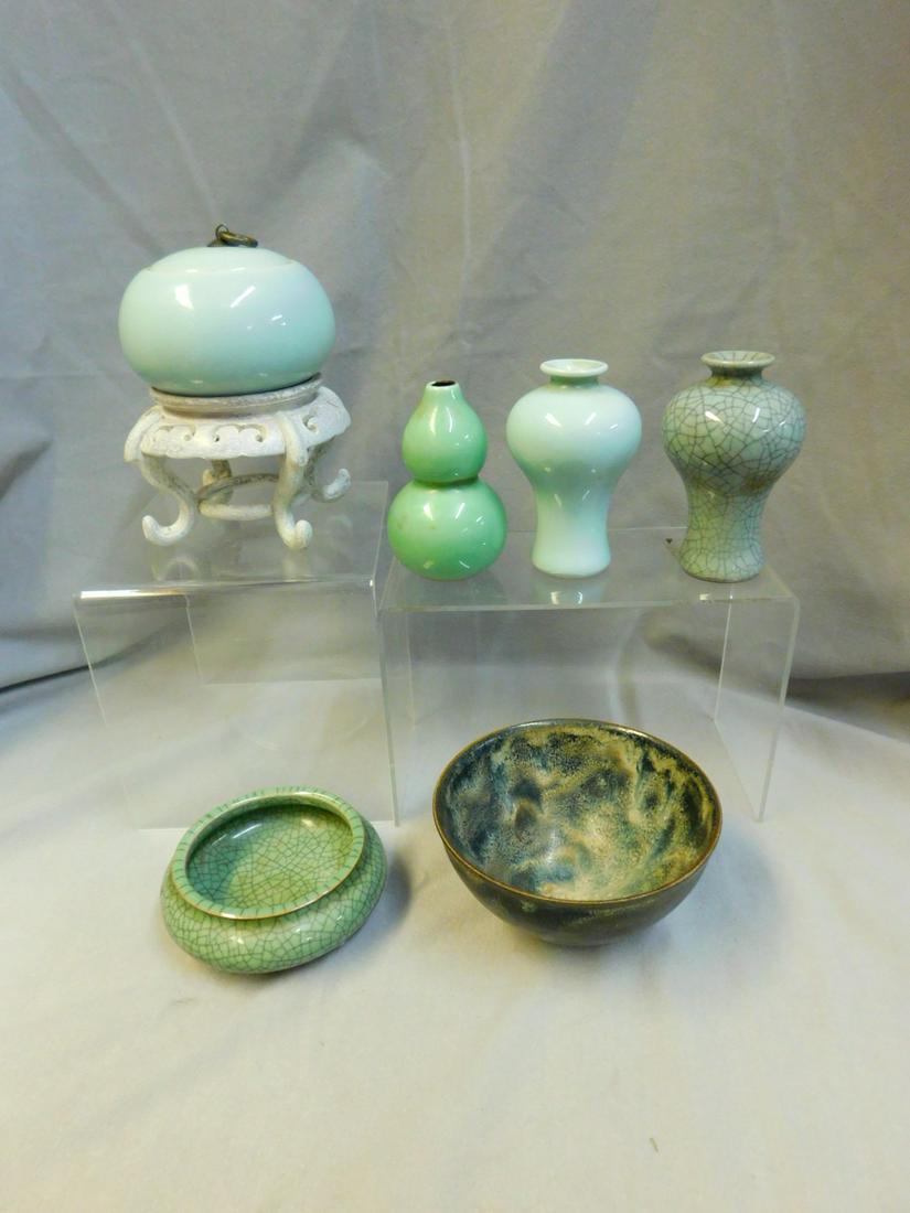 6 Oriental Pieces: Six Oriental Pieces includes: a 5"d drip glazed on brown pottery 2 3/4"h bowl; a 4"d celadon green glazed squat form covered jar with brass finial and cast chop mark; 4 1/4"d squat footed 1 3/4"h bowl