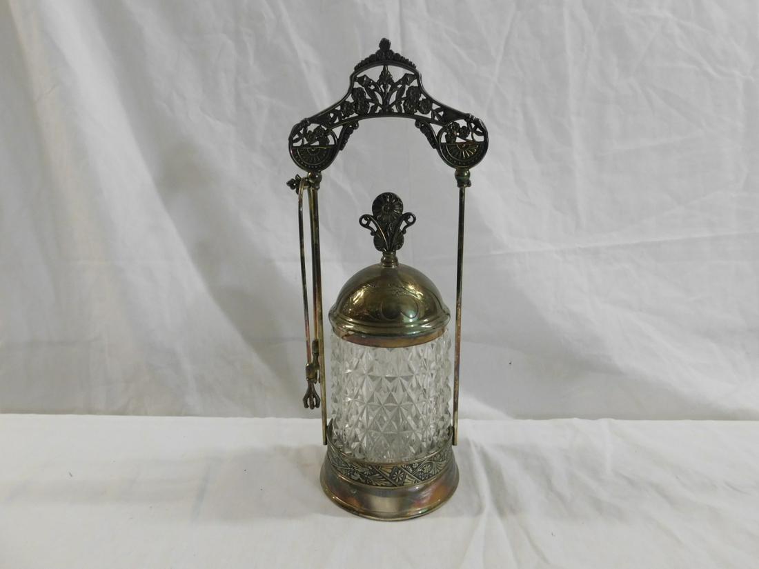 Victorian Pickle Caster: Victorian Pickle Caster, clear molded glass saw tooth pattern, caster rests in a silver plate stand with a floral pierced arched crest, plus tongs, 12"h, circa 1880-1895. CONDITION: Very good, tarnish