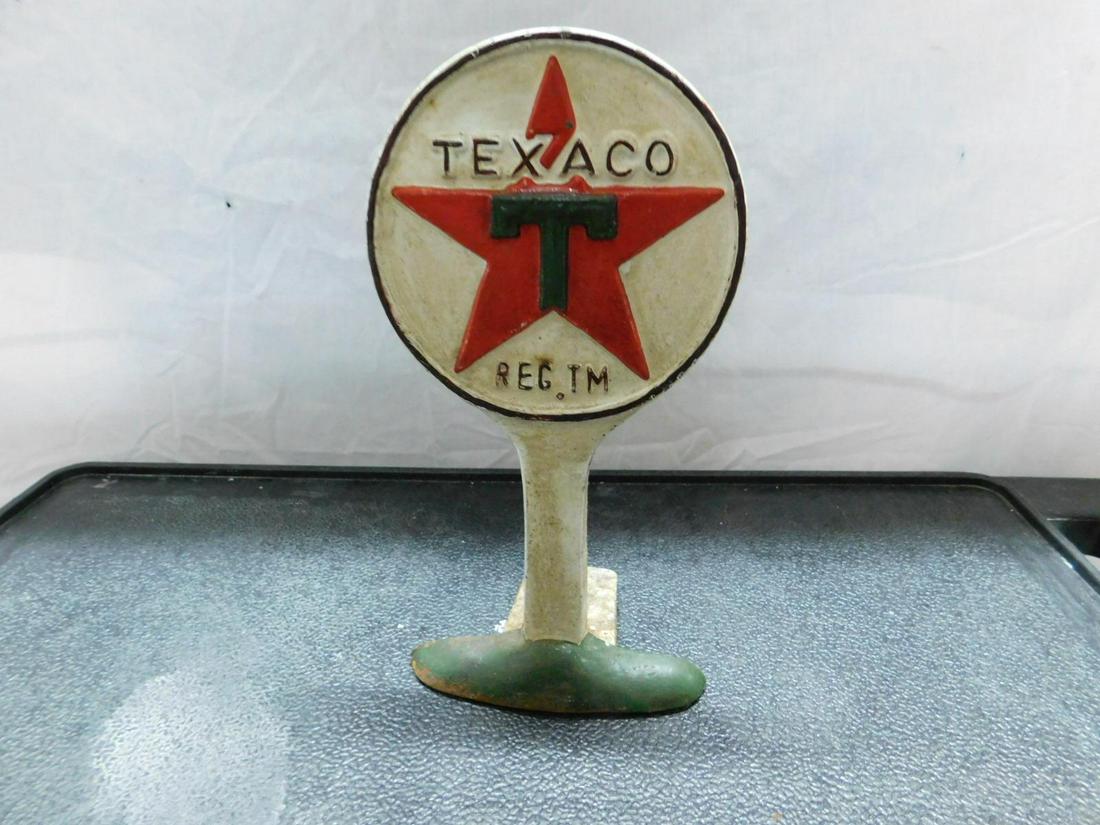 Vintage Texaco Cast Iron Door Stop: Vintage Texaco Cast Iron Door Stop, Texaco sign form, star in circle with T, hand painted, 5 1/4" x 3 3/4" x 9 7/8"h. CONDITION: Some paint loss around circle, minor rust wear some minor paint loss is