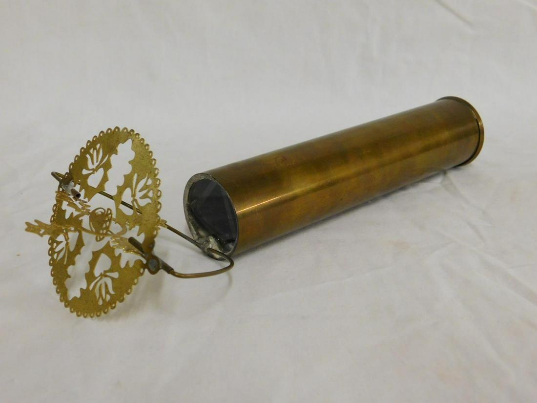 Brass Cylinder Kaleidoscope: Brass Cylinder Kaleidoscope with rotating pierced brass disk, signed illegibly "02", length 10". [6] CONDITION: Some tarnishing.