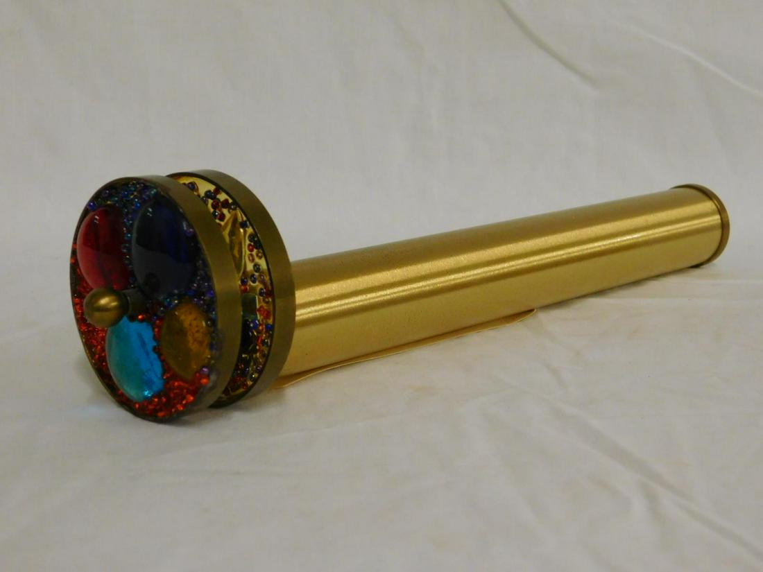 Brass Cylindrical Kaleidoscope: Brass Cylindrical Kaleidoscope with twin jeweled brass framed disks, length 10 1/2". [11] CONDITION: Areas of brass corrosion on one disk.