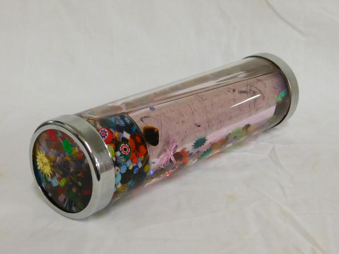 Lucite Fluid Filled Kaleidoscope: Lucite Fluid Filled Kaleidoscope filled with millifiori sections, [beads, etc., chromed ends; 2 5/8" d, 9 1/4" length. [12] CONDITION: Very good.