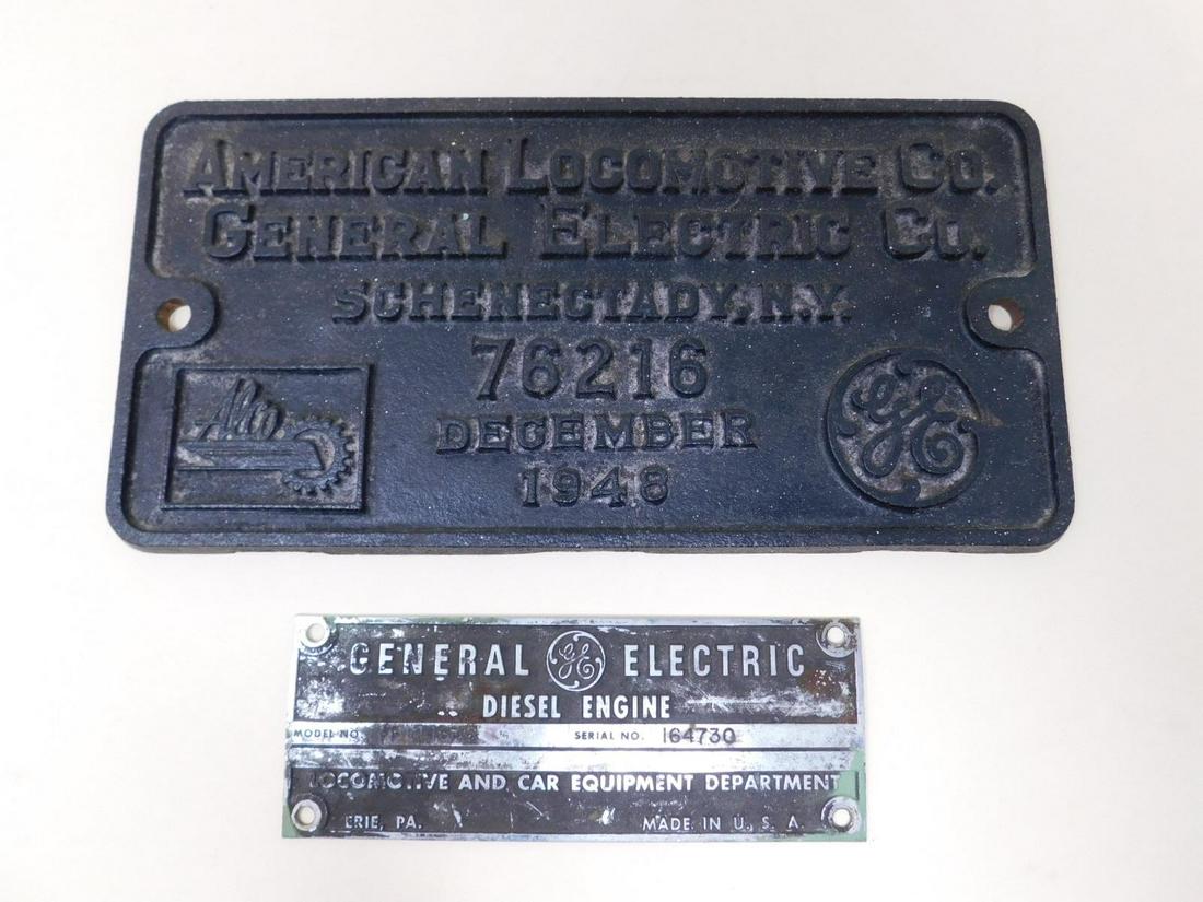 Two General Electric Locomotive Build Plates: One large cast iron plate from The American Locomotive Co / GE Co for locomotive 76216, the other for a diesel engine serial number 164730. Size: larger plate is: 12.25" X 6". CONDITION: In used condi