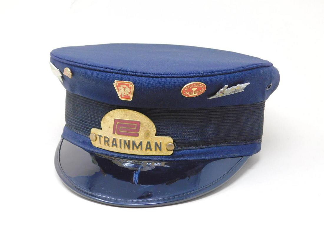 Penn Central Railroad Trainman's Hat: Penn Central Railroad Trainman's Hat by M.H. Grossman, Inc. Phila. PA, gilt and enameled metal Trainman logo; also includes: five small RR pins - Illinois Central, Western Maryland, PRR, Strasburg Rai