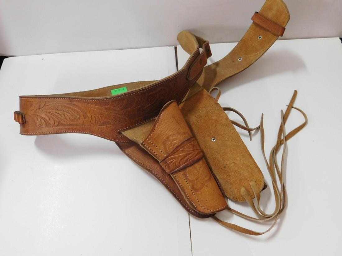 Early - Mid 20th C. Tooled Leather Gun Belt: Early - Mid 20th C. Tool Leather Gun Belt, double hanging holsters with leather thigh straps, tooled floral design on belt and holster fronts, twelve cartridge holders at back of belt, small buckle an