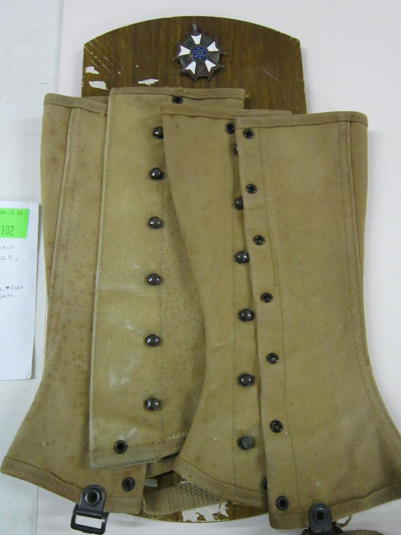 US Legion of Merit Medal & Spats: US Legion of Merit Medal and Spats, 1932, red, white, blue and green enameling on metal frame; plus a pair of WW I canvas army spats, size 12 E. CONDITION: Brass finish tarnished and worn, some scratc