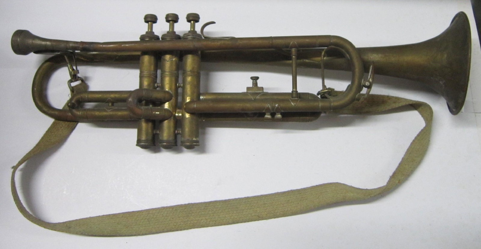 Beltone Trumpet: Beltone Trumpet, brass and scroll engraved with mouthpiece and carrying strap, 18" l. Condition: tarnished, some straightened folds in bell, brass mouthpiece juncture edges rough
