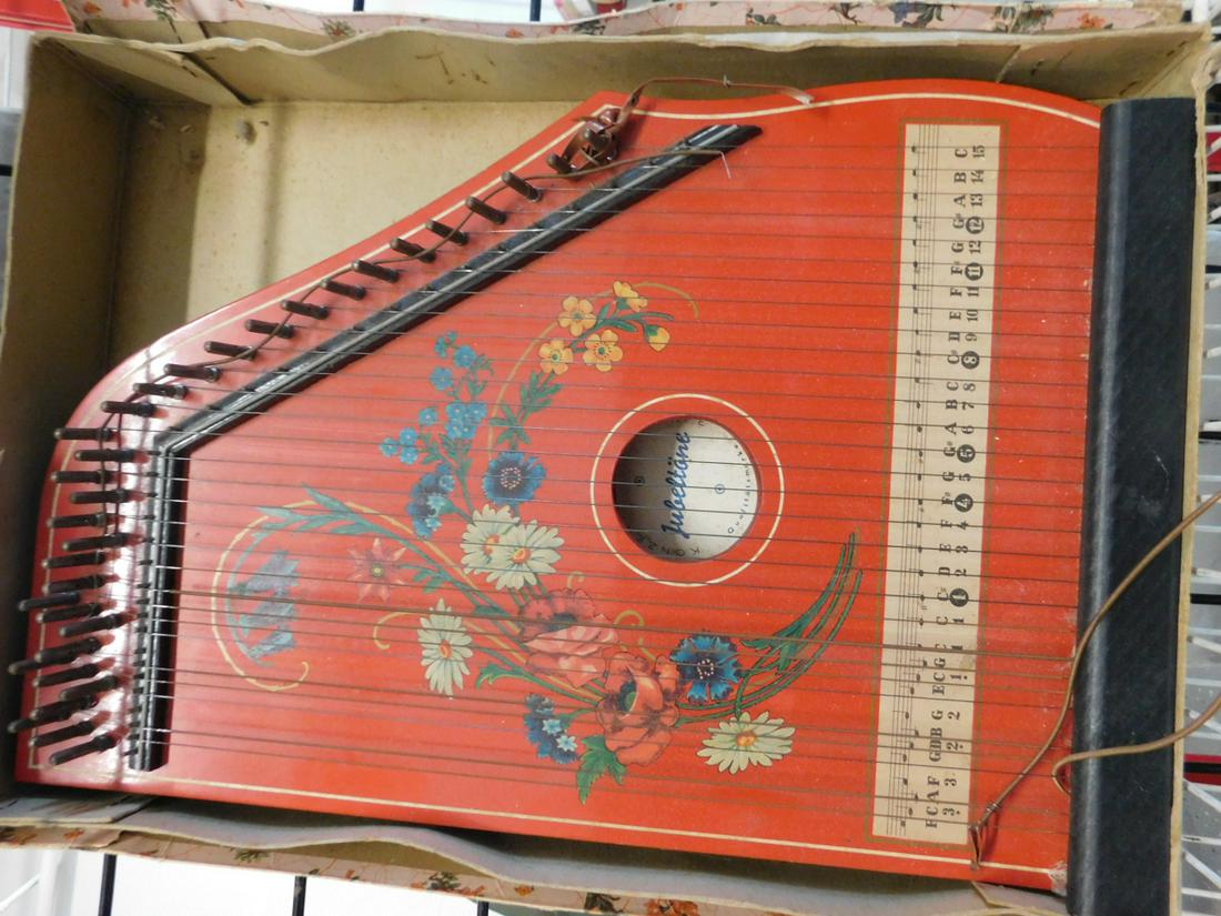 German Children's Zither Musical Instrument: German Children's Zither, floral decorated on red finished wood, "Kouzert - Salon-Horfe, Jabeltone", in original figural illustrated cardboard box, early 20th C, box 13" x 18" x 3". CONDITION: Light s