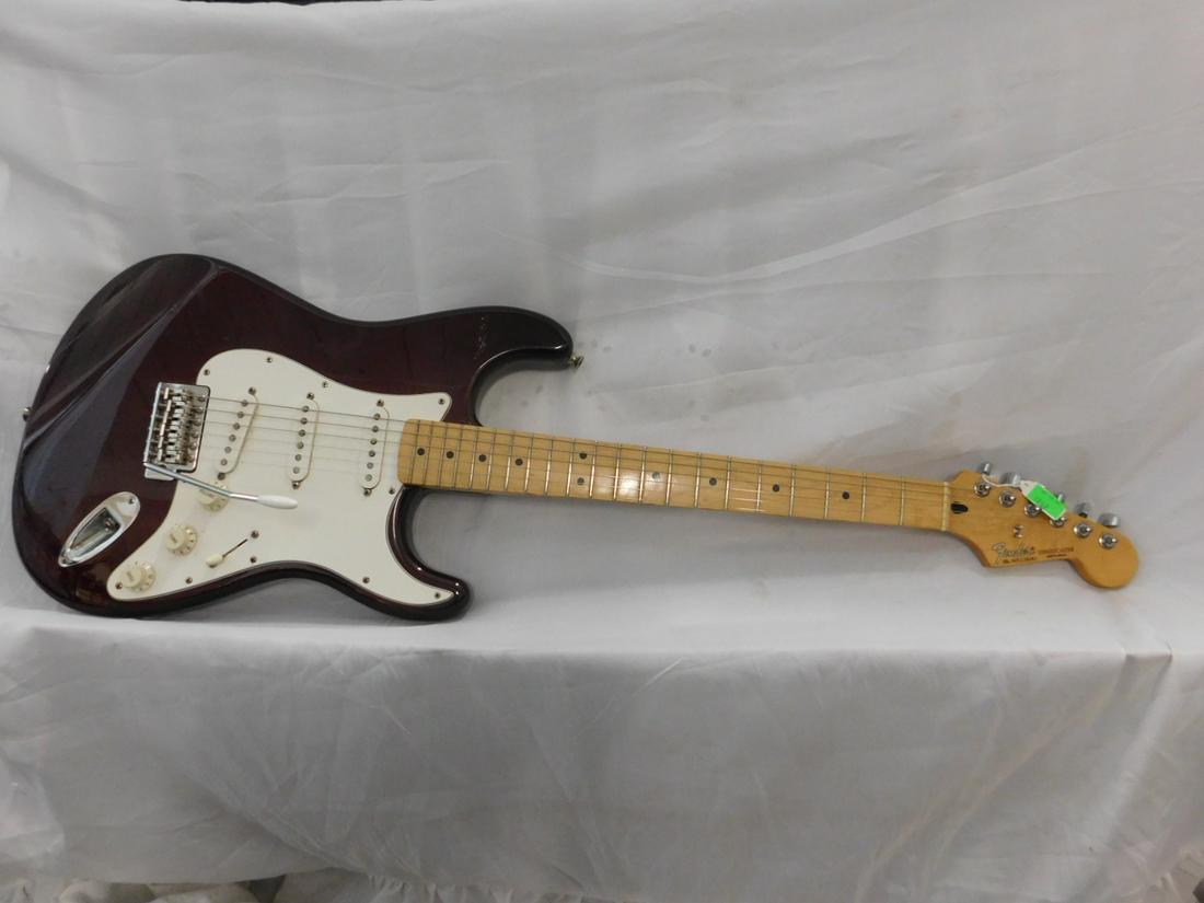 Fender Stratocaster Guitar: Fender Stratocaster #MZ0238087, solid body electric guitar (wine red). 6 string, Guitar 38 1/2"; neck 25 1/2" with case. CONDITION: Used, working.