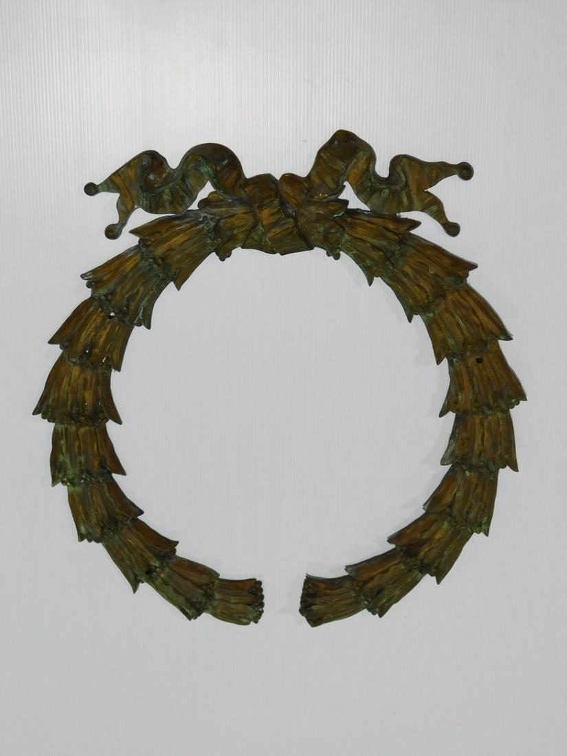 Bronze Architectural Wreath Ornament: Bronze Architectural Wreath Ornament. Cast and chased bronze low-relief wreath, of laurel leaves and berries, tied with a ribbon. In the Beaux Arts style, likely an architectural ornament. Threaded ho