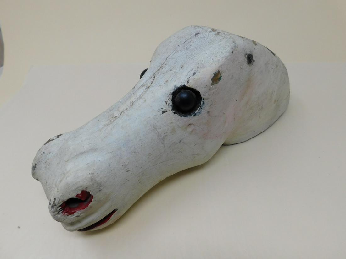 Small Scale Folk Art Horse Head: Small Scale Folk Art Horse Head, hand-carved wooden head, possibly from a small-scale carousel. Wooden eyes, nails where ears were attached, two dowel holes in back. Painted white over earlier paint.