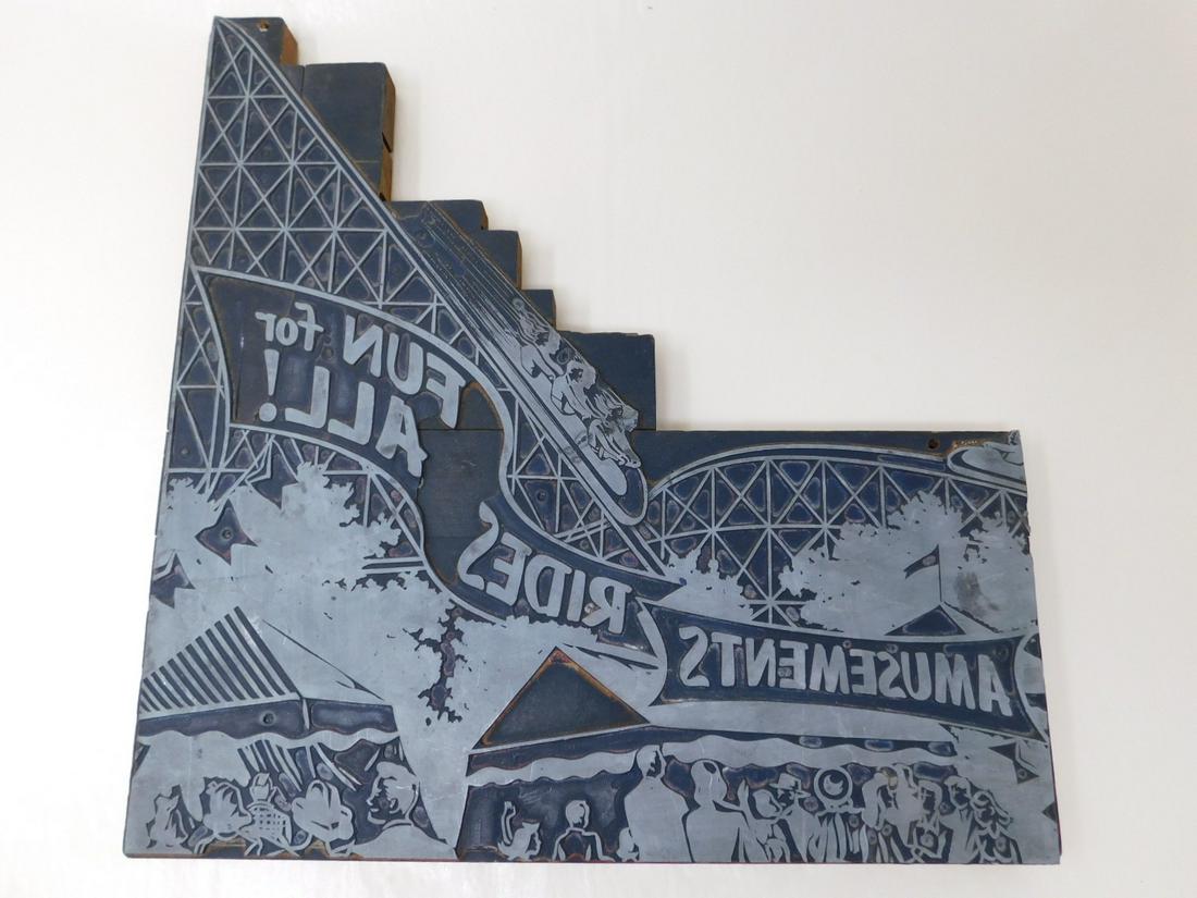 Carnival Rollercoaster Printing Block: A large metal printing block with wooden backing, for printing advertisments, showing a large roller coaster in action at a carnival, a crowd in the foreground. Size: 13.125" X 13.5" CONDITION: Wooden
