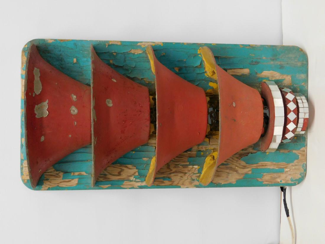 Art Deco Carousel Light #2: A vertical-form Art Deco style carousel light, consisting of a rectangular plywood backing board with four metal funnel-form reflectors (each containing two Edison sockets), mounted over three graduat