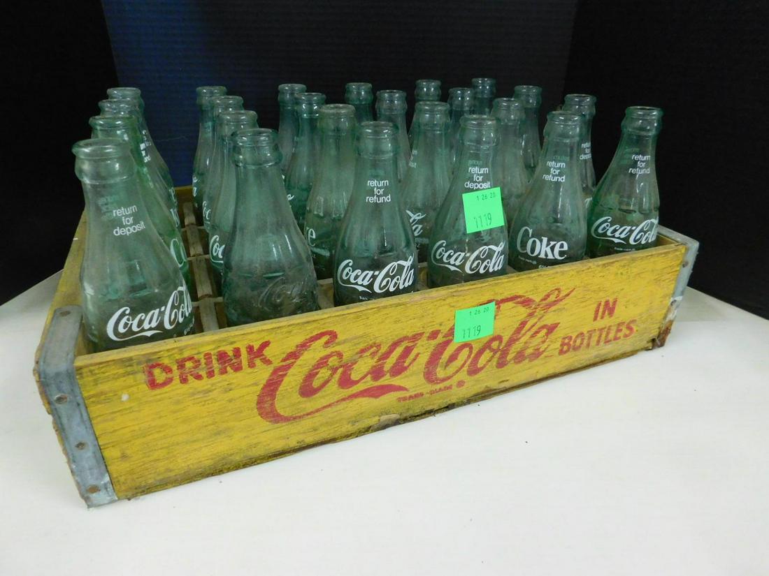 Coca - Cola Half Case with Return Bottles: Coca - Cola Half Case with Return Bottles, yellow case with 24 glass return bottles, case 12" x 18 1/2" x 4 1/2". Circa late 60s. CONDITION: Good, used condition.