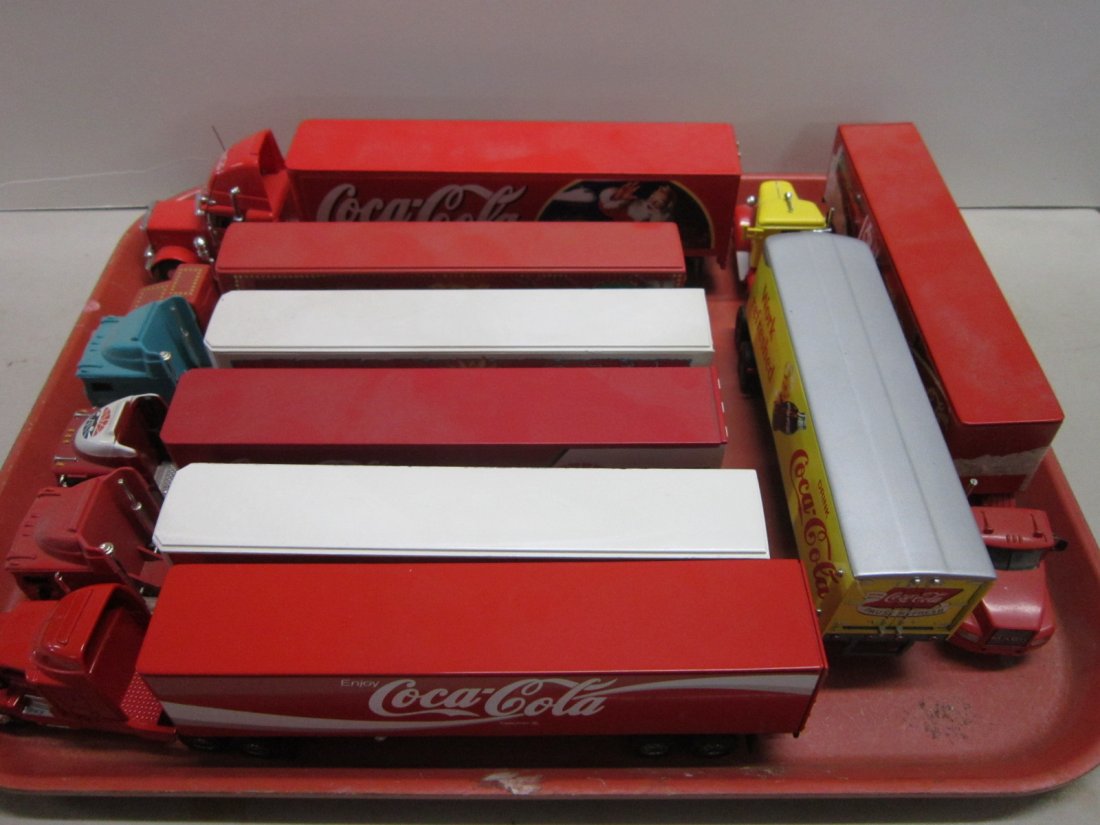8 Coca Cola Scale Model Tractor Trailers: 8 Coca Cola Scale Model Tractor Trailers including; Santa, Sprite boy, Charlotte Motor Speedway, Red Hot Summer and Coca Cola logo, all approx. 11" l. Condition; minor if any wear