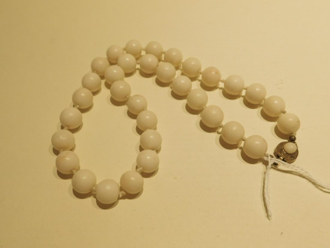 White Coral Bead Necklace: Coral Bead Necklace white coral 11mm beads individually tied, 800 gold-washed silver clasp, length 18". [48] CONDITION: Very good, used.