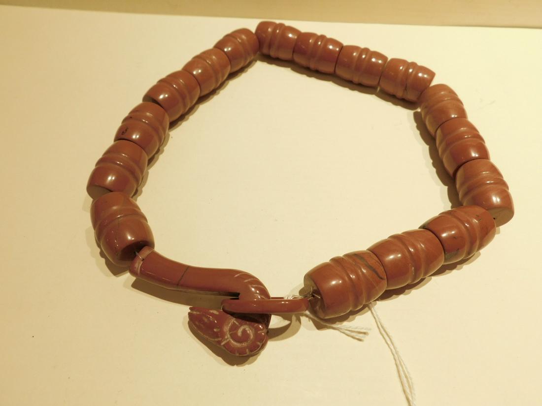 Carved Carnelian/Agate Necklace: Carved Carnelian / Agate Necklace; red/ brown carved possible Carnelian or agate with barrel form beads and carved Ram's head and ring claps, length 19". CONDITION: Very good, used.