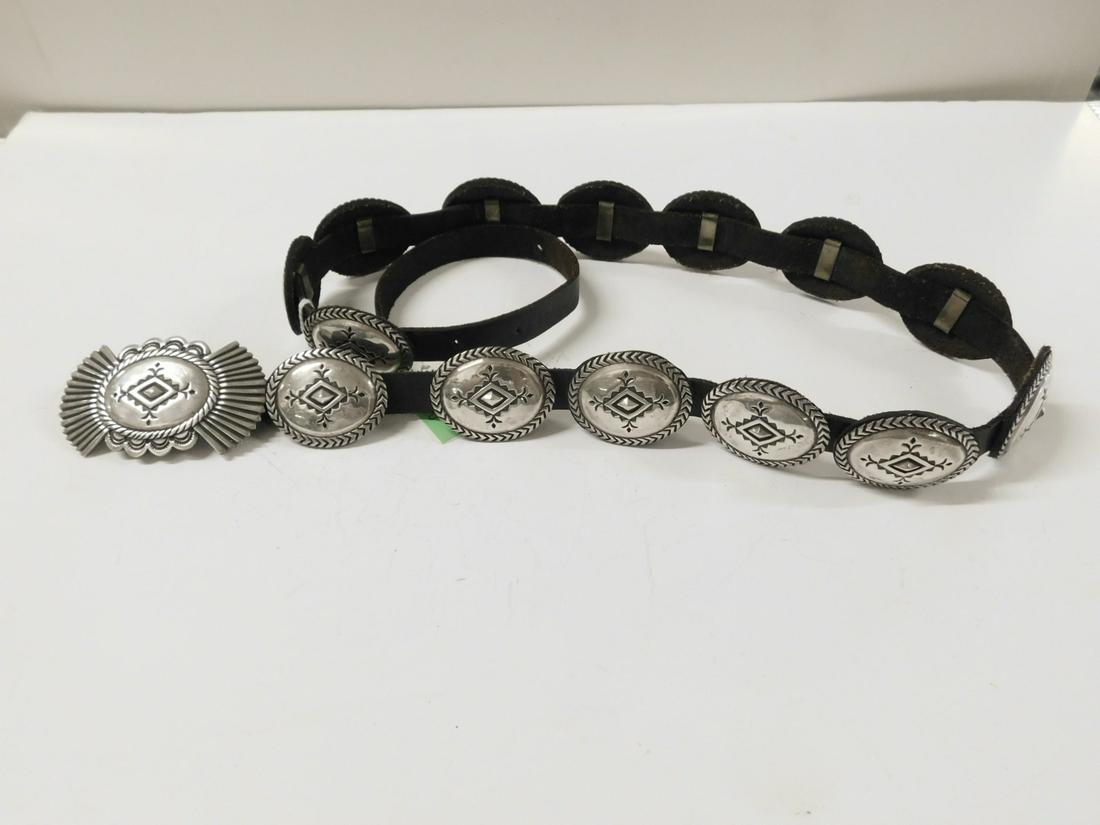 Navajo Silver Concho Belt: Navajo Concho Belt, signed Jeff Morri? Taos, tested silver, featuring15 oval medallions (1 1/2" x 1 3/4") and a winged buckle (1 5/8" x 3"), all with leather backs and thin leather belt, size - 36. Co