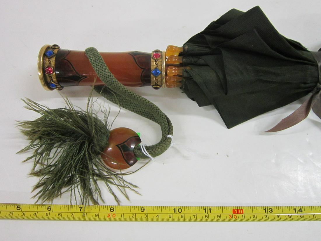 Jeweled Gold Filled & Bakelite Parasol: Jeweled Gold-Filled & Bakelite Parasol, gold filled top, top and bottom ends of handle capped with gold filled rims with bezel set jewels; amber bakelite shaft is carved and colored with black designs