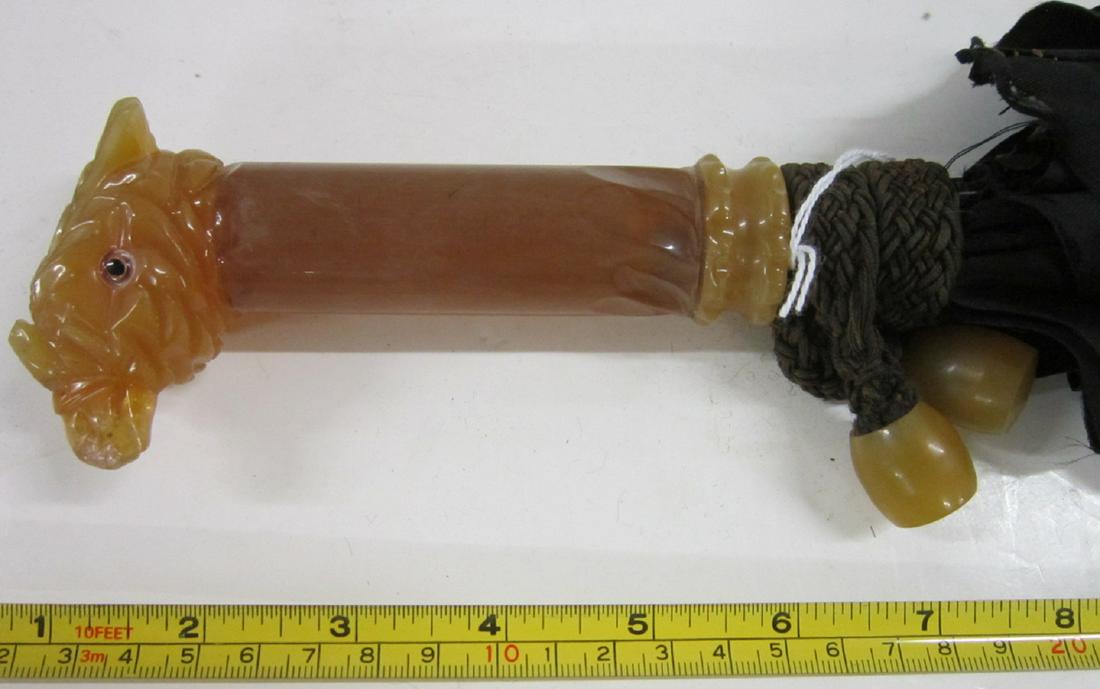 Bakelite Bird Head Crested Parasol: Bakelite Bird Head Crested Parasol, pale amber color bakelite, carved bird head with glass eyes on a cylindrical shaft, handle length, 5", overall length 29 1/4". Condition; wear to tip of bird's beak