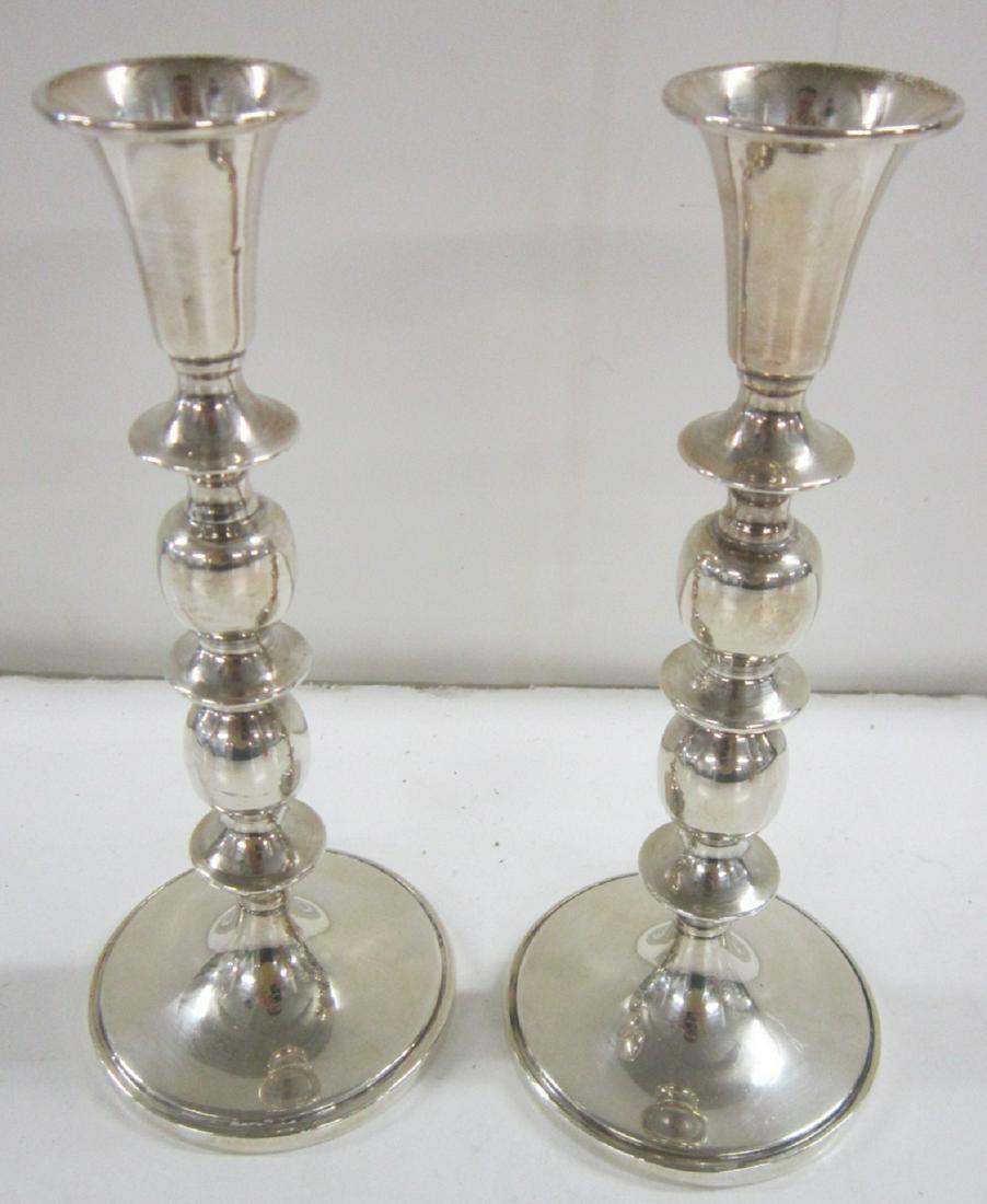 Pair Cartier Sterling Candlesticks: Pair Cartier sterling candlesticks, weighted, ring and ball turned columns on molded edge circular base, model #165, 6 1/2" h. Condition; very good, no issues noted