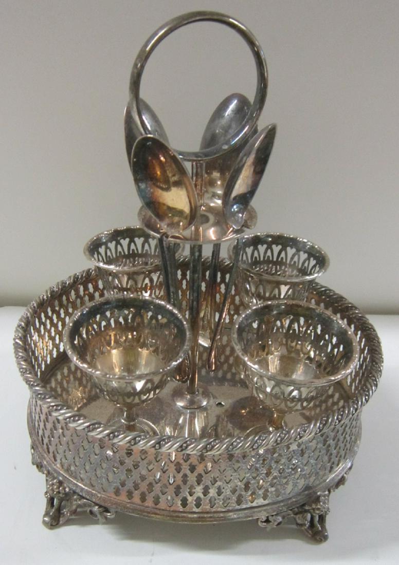 English Silverplate Egg Stand: English Silverplate Egg Stand: An English silverplate egg stand or server in the Edwardian manner, consisting of an oval footed stand with pierced gallery with rope-twist edging, with a central handle