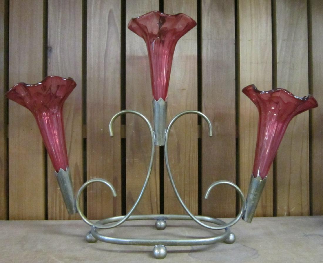 Three Horn Metal & Glass Epergne: Three Horn Metal & Glass Epergne: A silverplated metal frame supporting there cranberry glass horns. Late 19th or very early 20th century, most likely English. Size: 13 1/4" h. x 18" w. CONDITION: Lig
