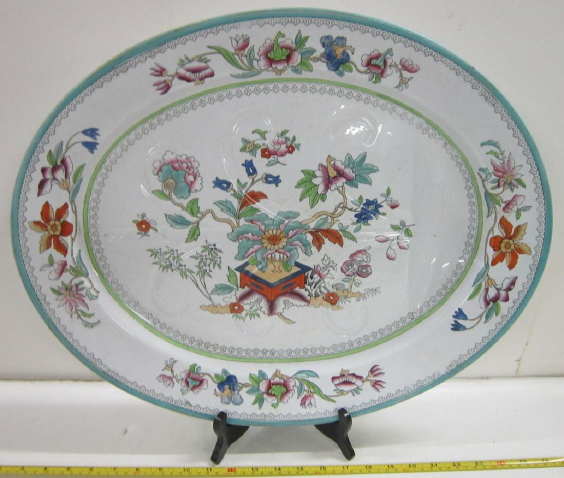 Antique Ironstone Meat Platter: Antique Ironstone Meat Platter, no maker's mark, Ming Tree pattern, floral border, ironstone platter with well and feet. Late 19th c. Size: 22" x 17 1/2" x 3". CONDITION: Some minor flakes/wear along 
