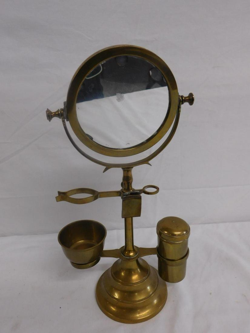Antique Brass Shaving Stand with Mirror: Antique Brass Shaving Stand with Mirror, a compact brass stand supporting a two-sided mirror, brush-holder, razor-holder, canister, etc. Probably English, 19th or early 20th c. 13 1/2" h. CONDITION: S