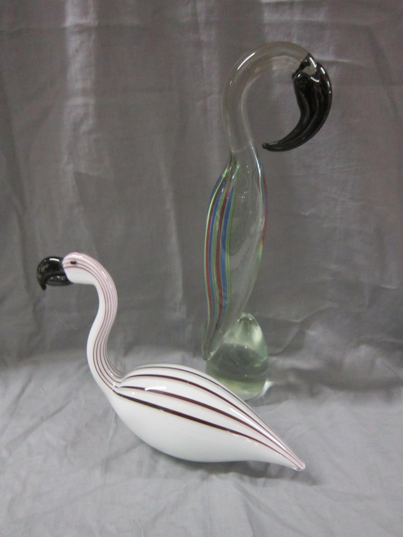 Two Murano Glass Wading Bird Figures: Two Murano Glass Wading Bird Figures: Consisting of two flamingo-type birds, one in crystal inlaid with several colored stripes/threads, standing on a rock, the other seated, in black and white stripe