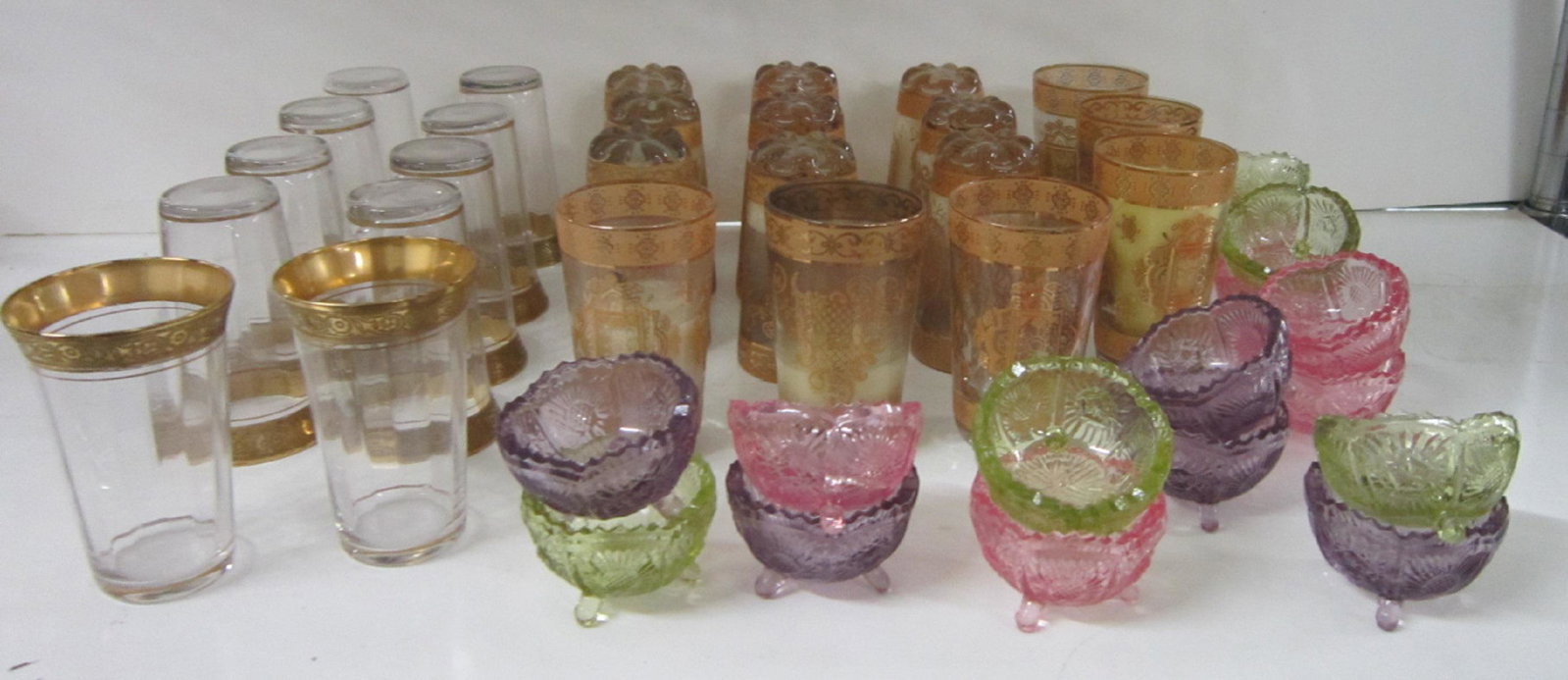 Gilt Crystal Juice Glass Lot: (43 pieces) Gilt Crystal Juice Glass Lot: Consisting of (12) 3 5/8" h. Minton band etched, gold encrusted juice tumblers, (15) 3 5/8" h. gold-decorated, heavy-bottomed tumbler (some of which have cand