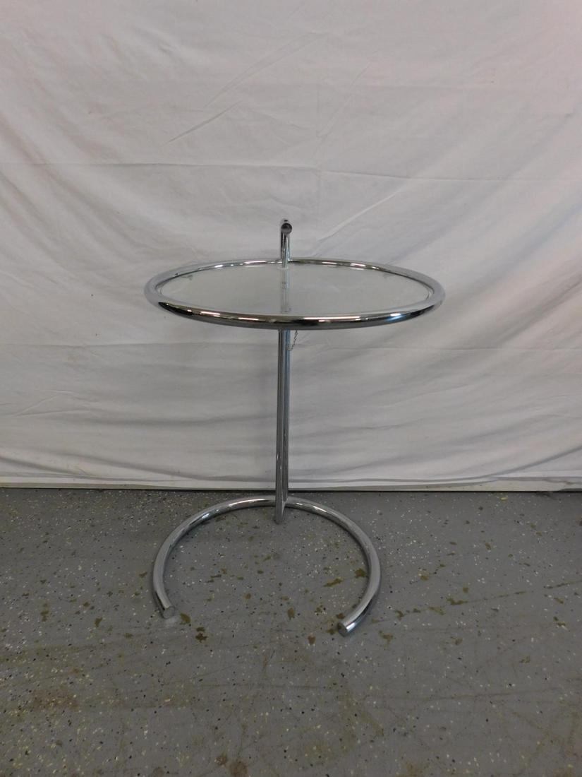 Eileen Gray E1027 Side Table: Eileen Gray E1027 Side Table. An adjustable chromed metal and glass ocassional table designed by Eileen Gray in 1927. This example late 20th c, likely manufactured by Zeev Aram. 24" h. at lowest posit