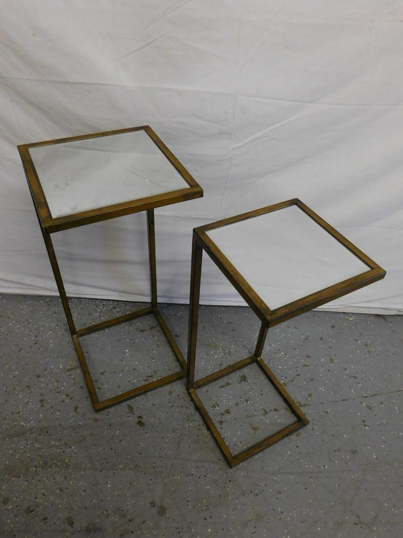 M.C.M. Nest of Tables: M.C.M nest of tables two graduated distress gilt square tubular metal in 'C' form with mirrored bevel glass tops, 13" x 13" x 29 1/2". CONDITION: One glass top with 3" and other scratches, areas of gi