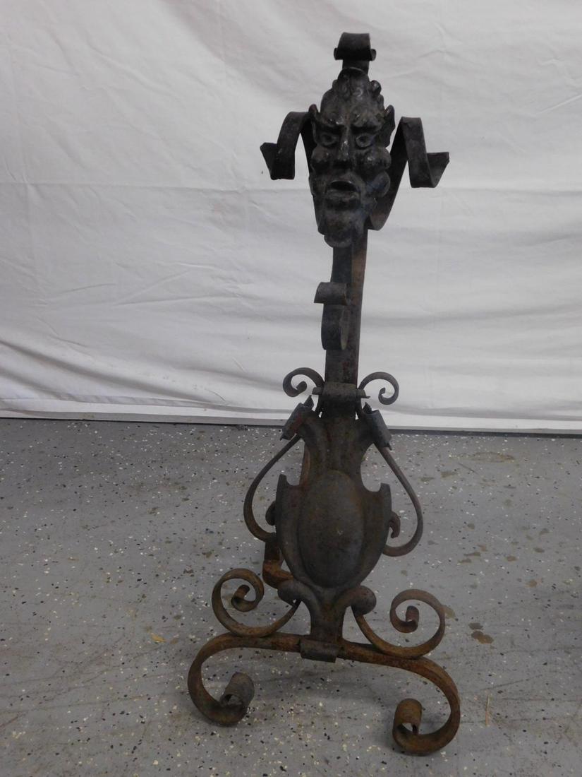 Gothic Forged Andirons: Gothic Forged Andirons, wrought iron; scrolled crest with cast iron grotesque masks; columns with applied wrought scrolls and hammered metal shields, scroll work bases, 19th C, 29"h, 12"w. CONDITION: 