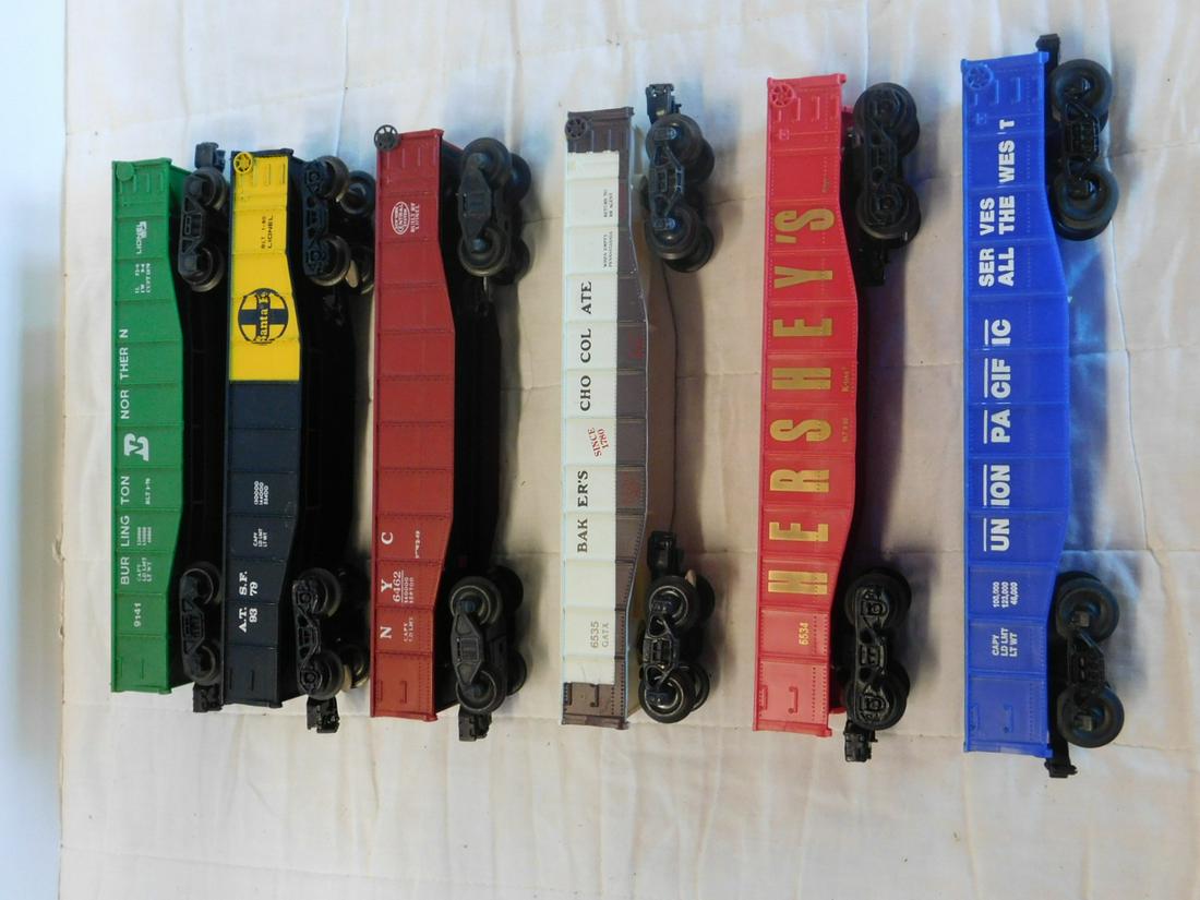 6 Lionel & Other Gondola Train Cars: Six Lionel & Other Gondola Train Cars, "O" gauge, loose, no boxes, Modern era including: Lionel - Burlington Northern 9141, Santa Fe 9329 , Bakers Chocolate 6535 and Post War New York Central 6462, re