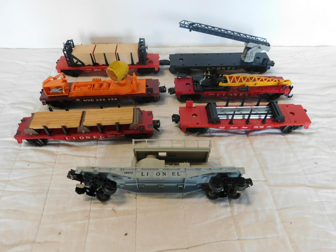 7 Assorted Lionel Flat Cars w/Accessories: Seven Assorted Lionel Flat Cars w/Accessories, "O" gauge, loose, no boxes including: Post war - lumber car 6264 (with lumber), Derrick car 6660, Cherry Picker car 6512, plus Modern era - Track Mainten