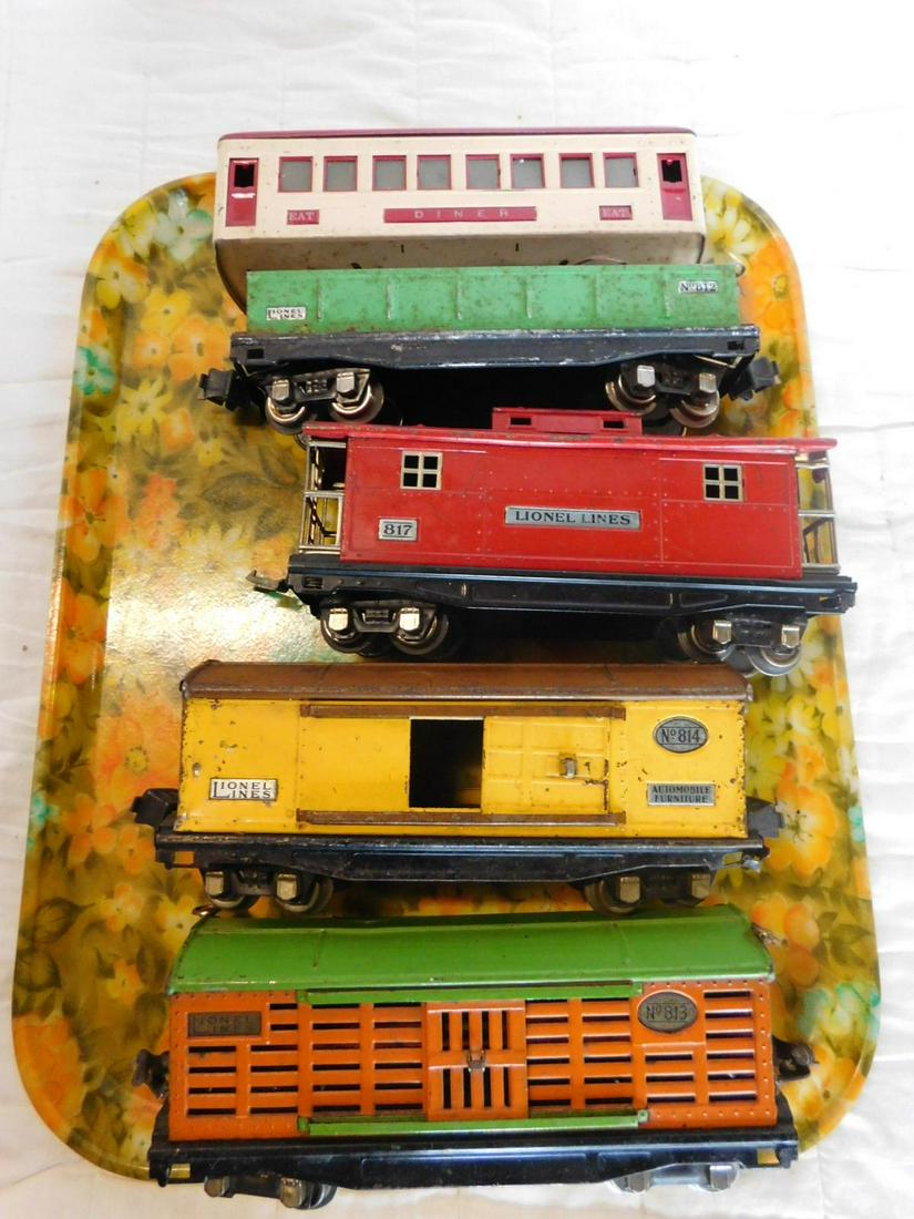 5 Lionel Tin Prewar Train Cars & Diner: 5 Lionel Tin Prewar Train Cars & Diner, "O" gauge, loose, no boxes including: Red Caboose 817, yellow automobile furniture car 814, cattle car 813, orange with green top and accent and Gondola 812, gr