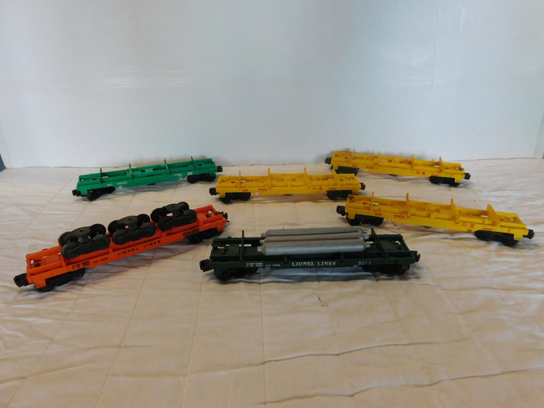 6 Lionel Operating Flat Dump Cars: Six Lionel Operating Flat Dump Cars, "O" gauge, loose, no boxes including: Post war - Lionel Lines Helium Tank Dump car (with three tanks), 3362 and Truck car (with three sets of wheels), 636255, plus