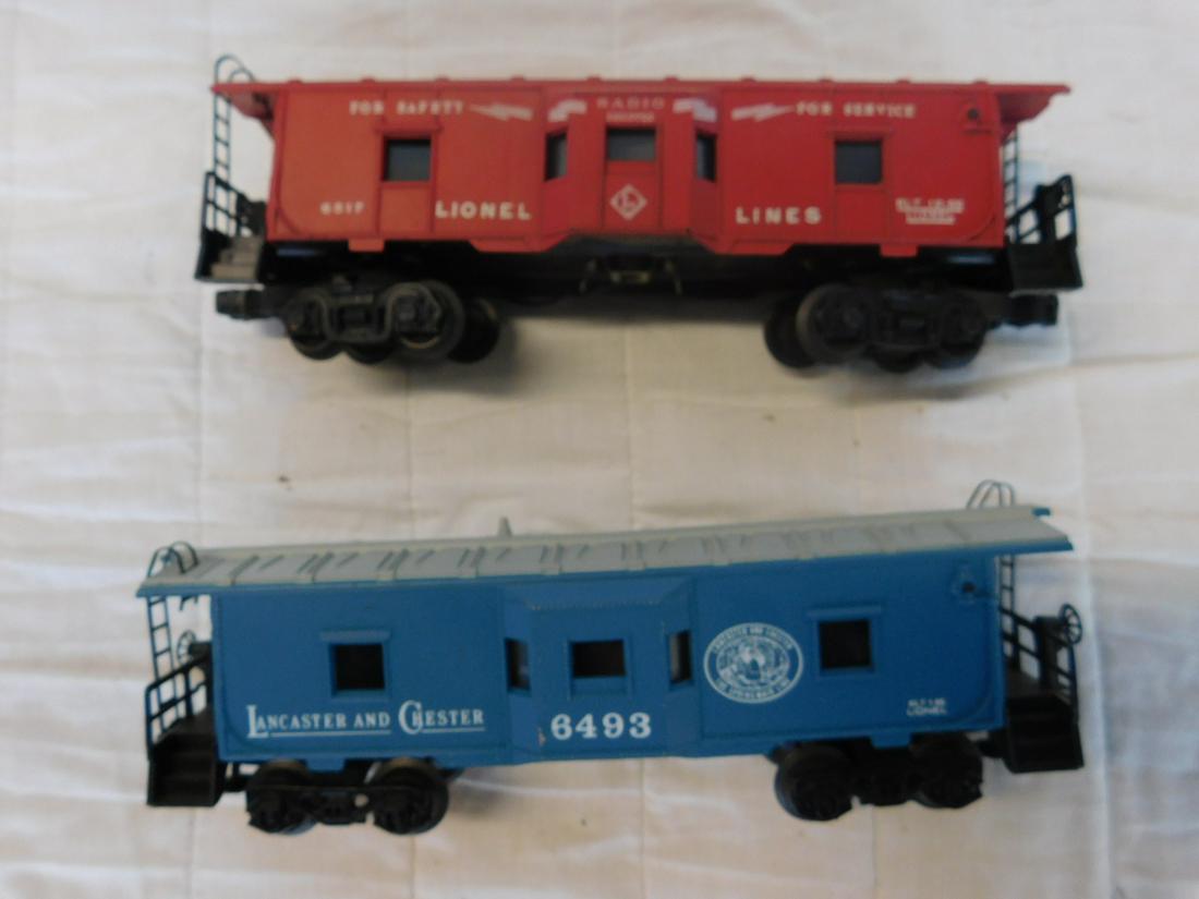 2 Lionel Window Caboose: Two Lionel Window Caboose, "O" gauge, loose, no boxes including: Post war - Lionel Lines bay window caboose, 6517 (variation A) red, "Radio Equipped for Safety - for Service", plus Modern Era - Lancas