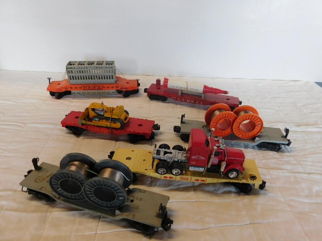 Assorted Flat Transport Train Cars: Assorted Flat Transport Train Cars, "O" gauge, loose, no boxes including: Post war - Rocket car (with U.S. Navy car), 6175, two Lionel Lines Depressed Center Cable Reel car, 6561 (each with two reels,