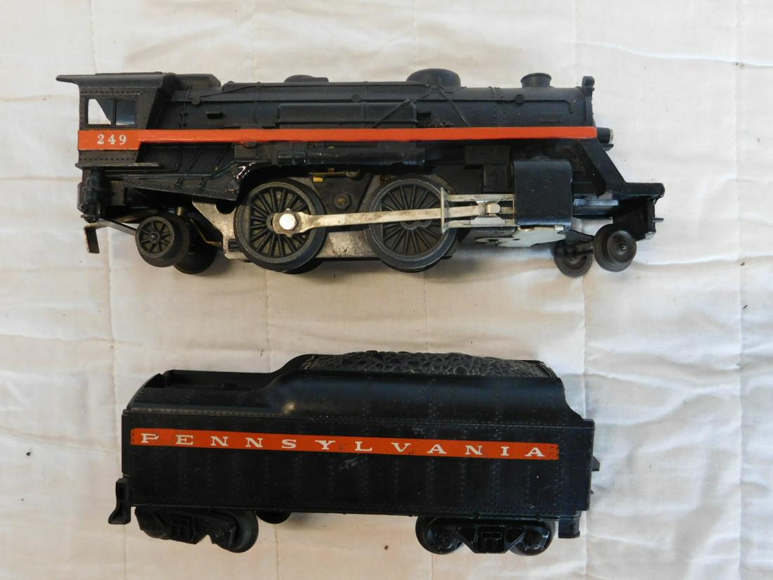 Lionel Post War Locomotive & Tender: Lionel Post War Locomotive and Tender,"O" gauge, loose, no boxes, Columbia type 242 locomotive, No. 249 with matching tender, red - orange stripe with heal stamped letters and numbers. CONDITION: Used