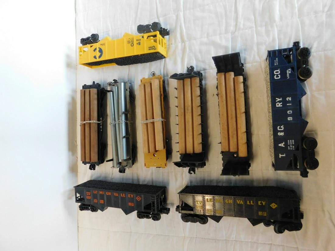 9 Lionel & Other Hopper & Flat Cars: Nine Lionel and Other Hopper and Flat Cars, "O" gauge, loose, no boxes including: Lionel Post War pipe car 2411 (with three pipes), Modern Era Lionel - Reading 48045, A.T.S.F. 9022 and Union Pacific 9
