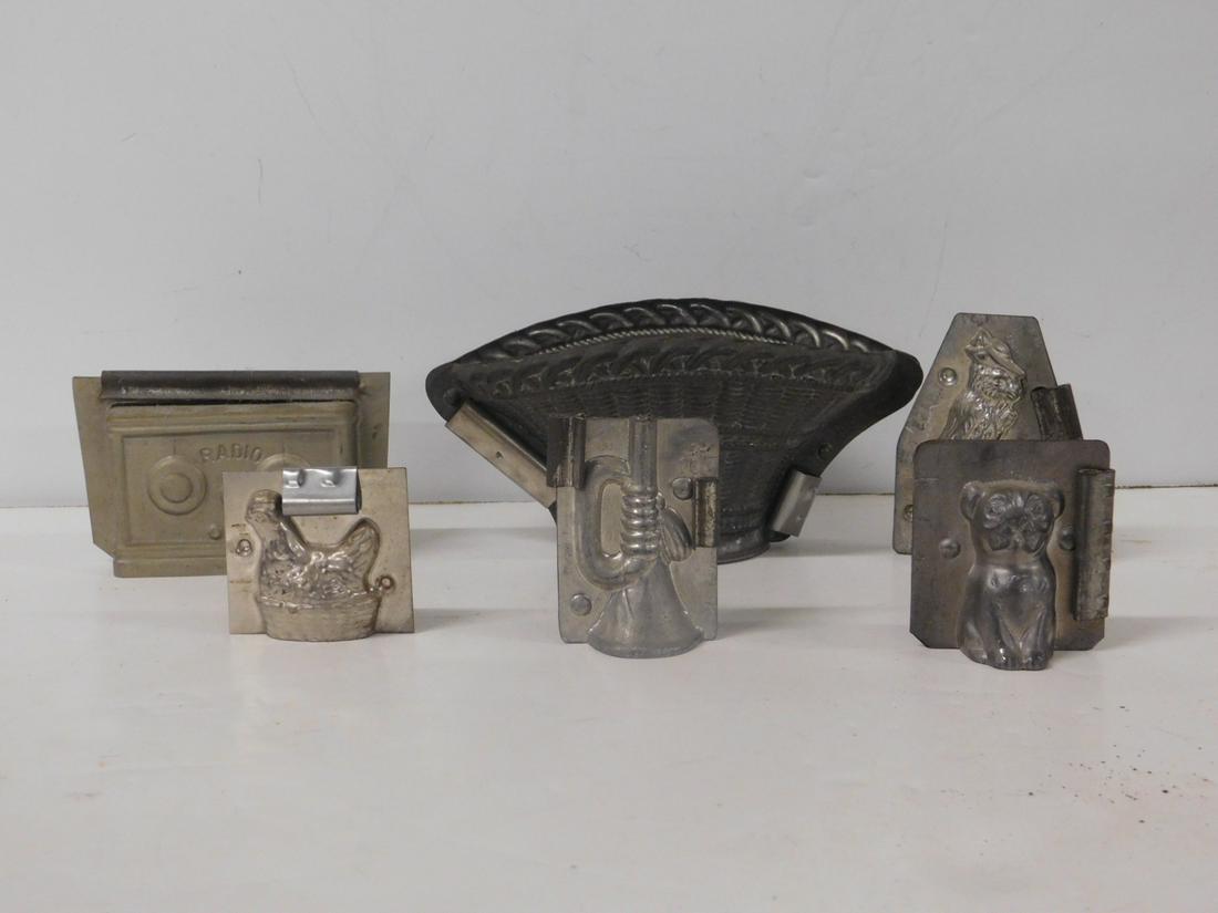 6 Vintage Chocolate Molds: Six Vintage Chocolate Molds, all metal in two parts, includes: large basket "Made in France" for T.C. We Candy N.Y.", 8" x 4 1/2" x 3 3/4", rabbit pushing wheel barrel - Made in Germany, 4" x 3" x 1 1
