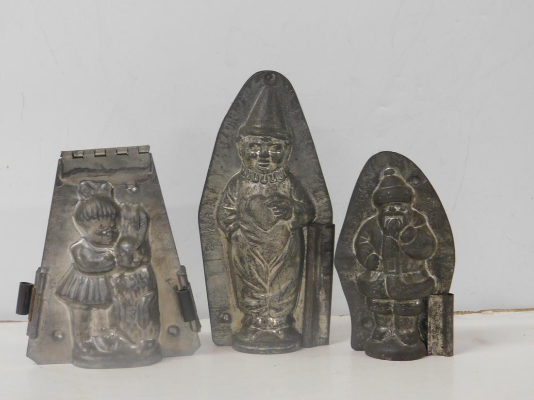 3 Metal Chocolate Molds: Three Metal Chocolate Molds, in two parts with clips, includes: standing Santa Clause #446, 3" x 5" x 1 1/2", girl with rabbit, hinged, 4" x 5" x 1 1/2", standing clown with heart #24716 by Anion Reic