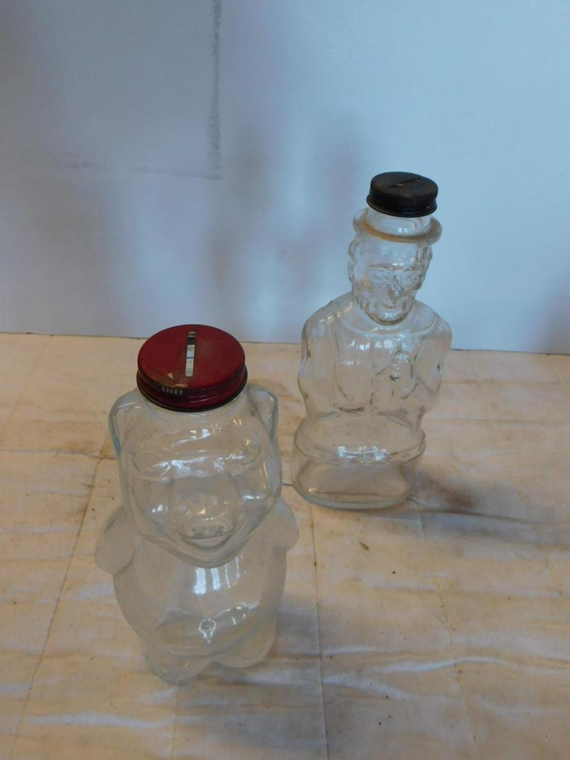 5 Vintage Coin Banks: 5 Vintage Coin Banks including: two glass with tin screw caps, Abraham Lincoln (Lincoln Foods, Inc) figural glass bottle, 8 1/2"h and Pig with hands behind it's back (pat.pend.), 7 3/4", plus tin mant